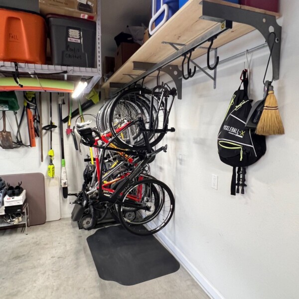 Wall mount brackets used to make a sliding bike storage area with shelf. Wall mount with shelf and large sliding hooks.
